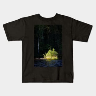 Small lush island in sunlight at lake shore Kids T-Shirt